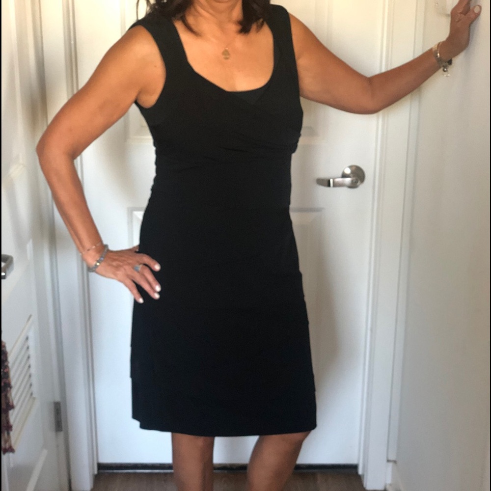 Beautiful black cocktail dress. Accentuates your body curves in a very soft fit.